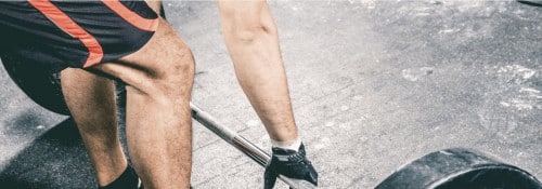 Closeup of a man preparing for a deadlift exercise.