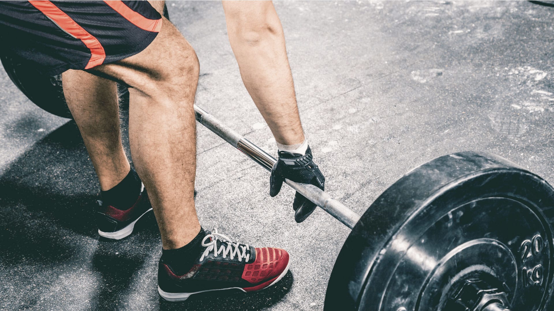 Closeup of a man preparing for a deadlift exercise.