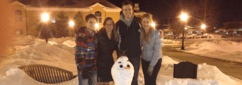 students with snowman on quad