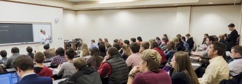 Room full of students listening to a lecture.