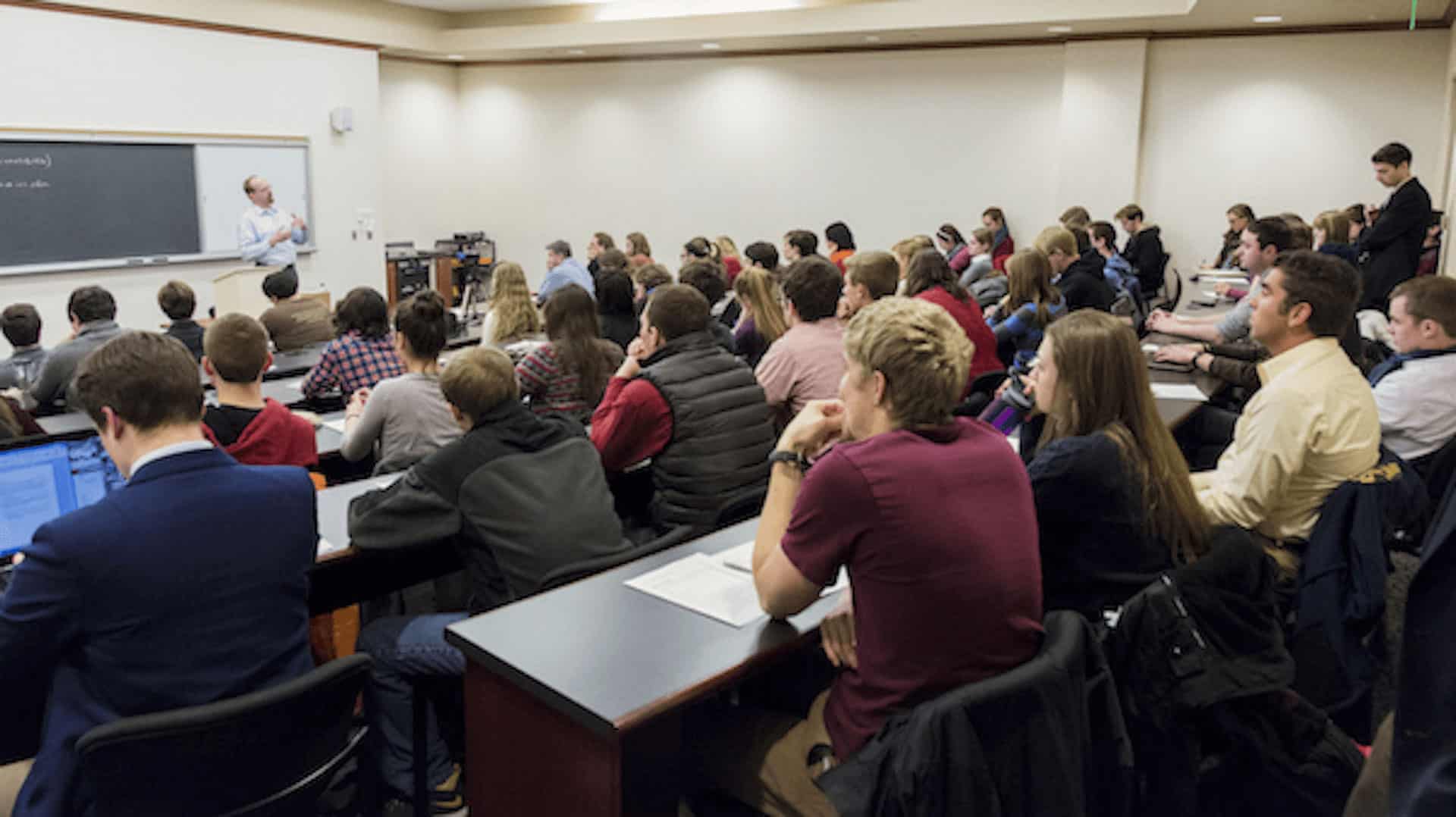 Room full of students listening to a lecture.