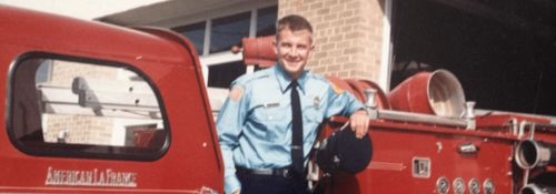 Erik Prince standing in front of a firetruck.