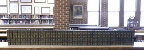 A large book collection sitting on a shelf in the Hillsdale College library.
