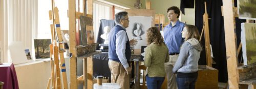 students talking to art professor