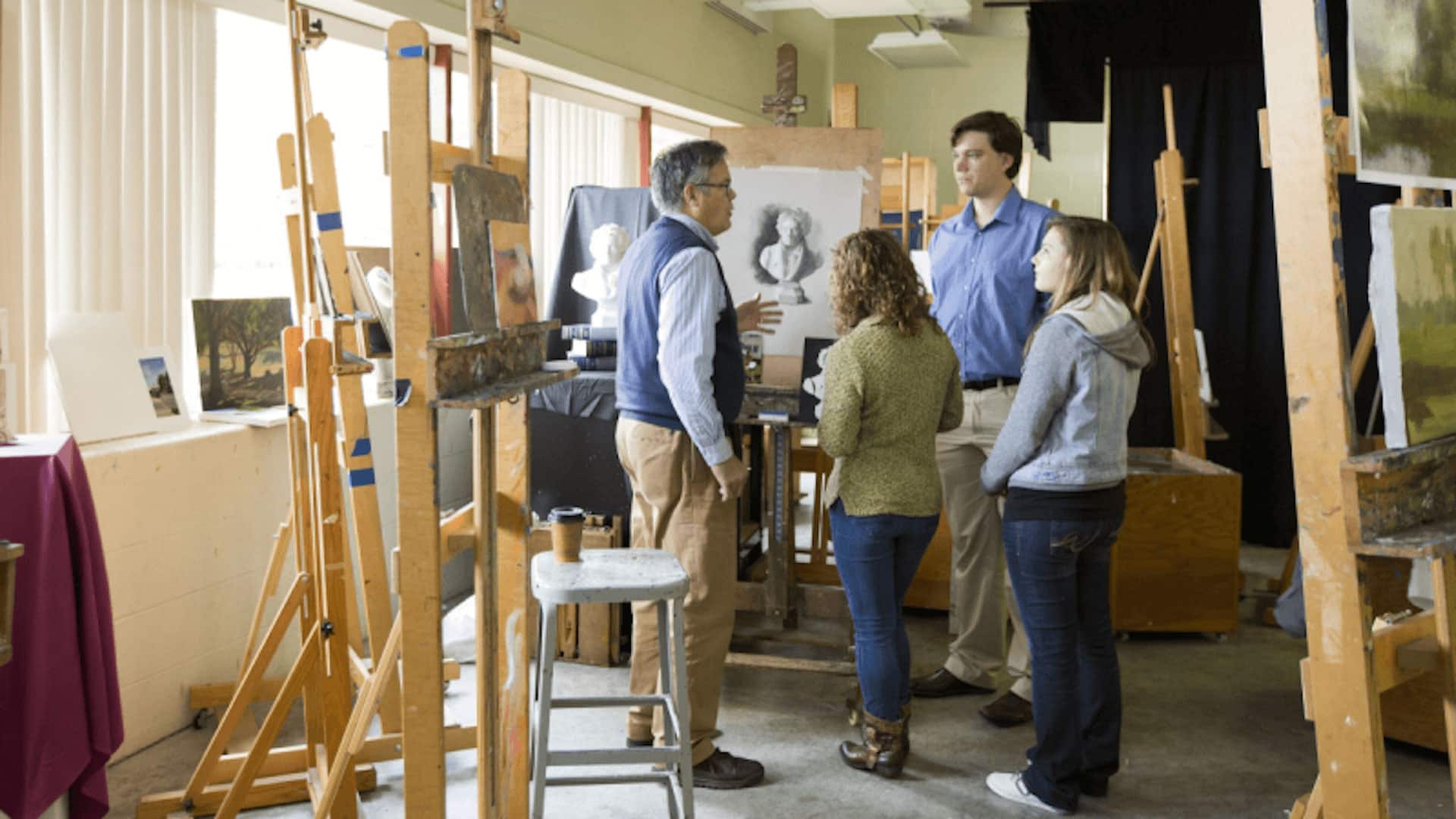 students talking to art professor