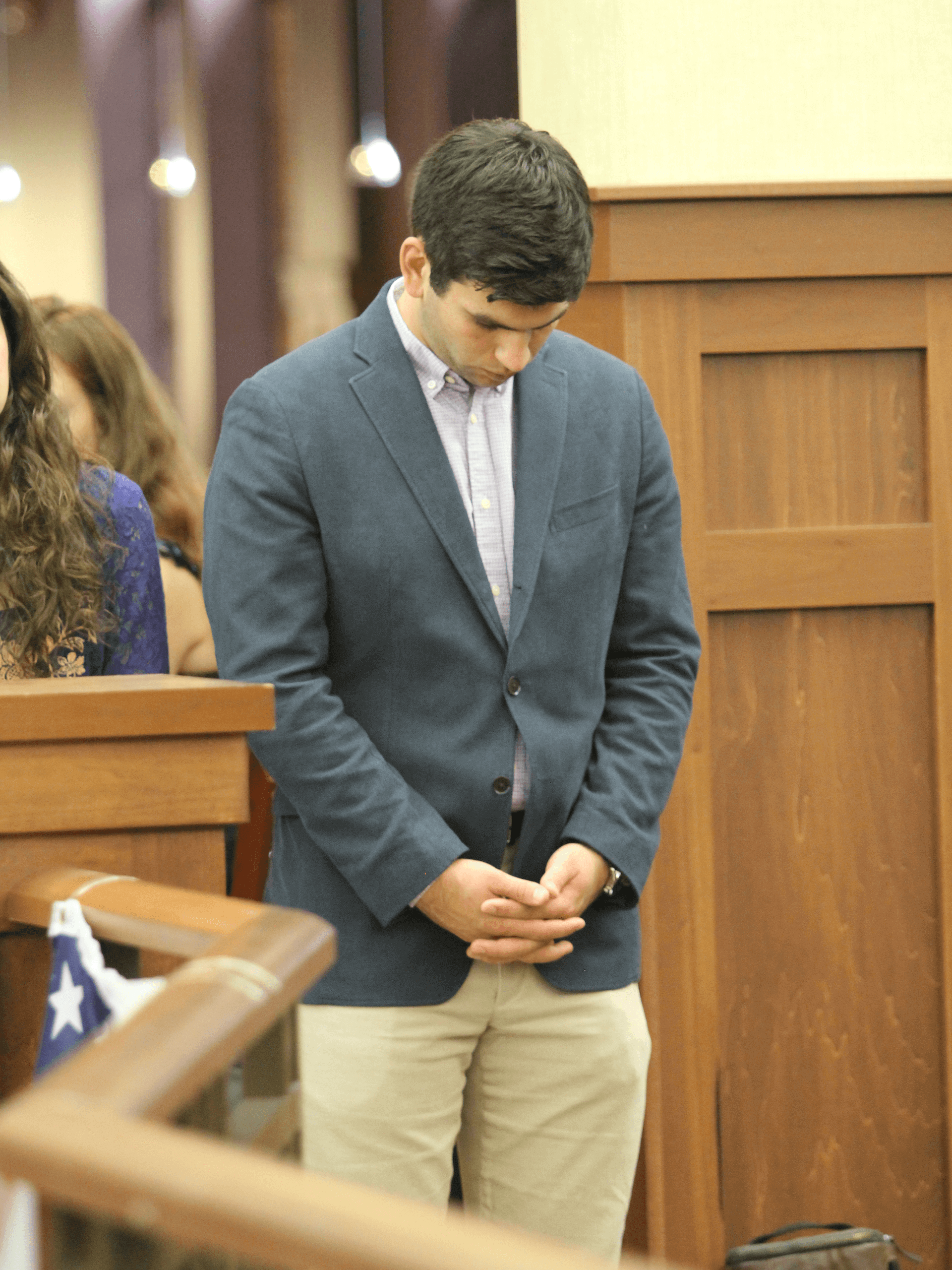 Student bows head in moment of silence