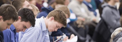 CCA attendees taking notes during a lecture.