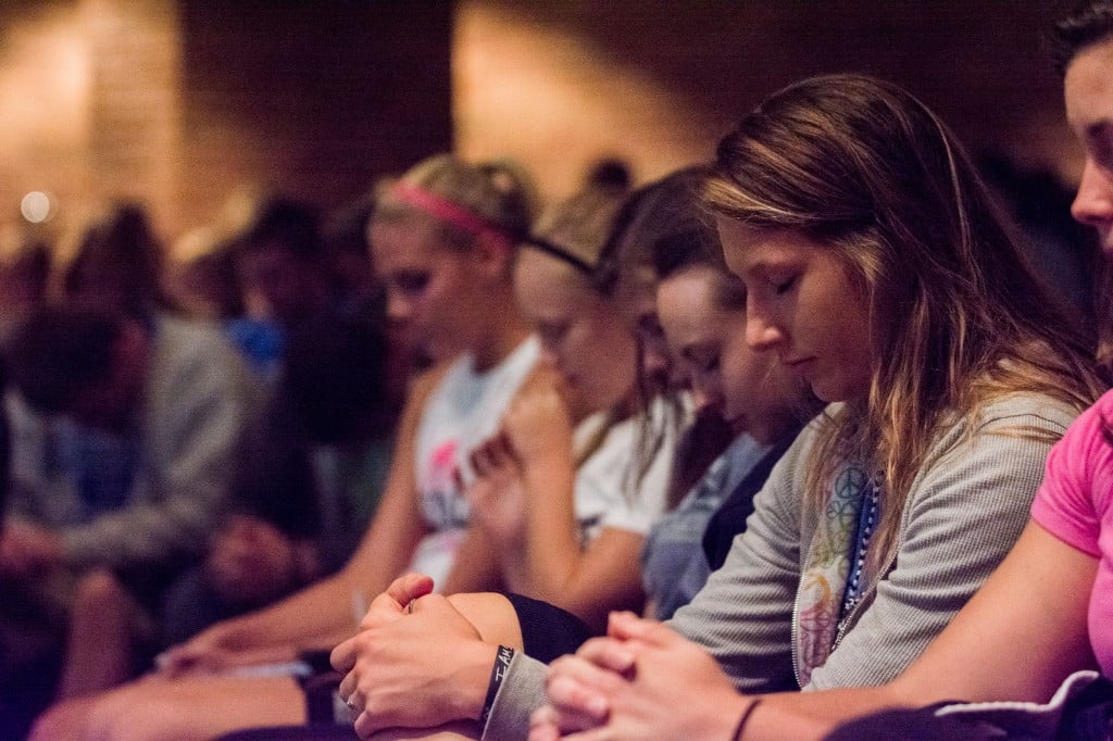 Hillsdale College Intervarsity members praying before a game.