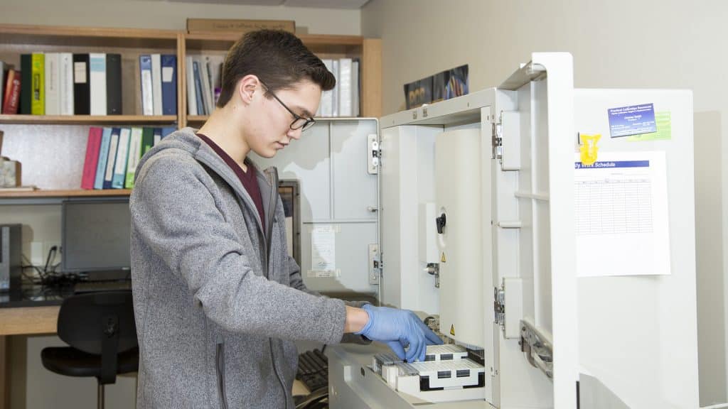 Biology student working with lab equipment.