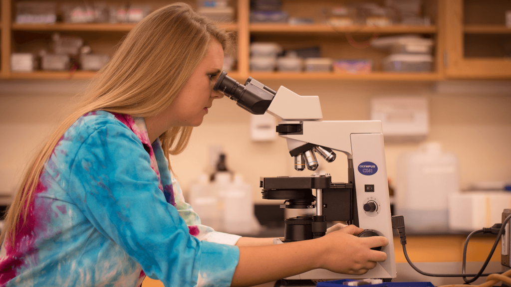 Lindsey using a microscope