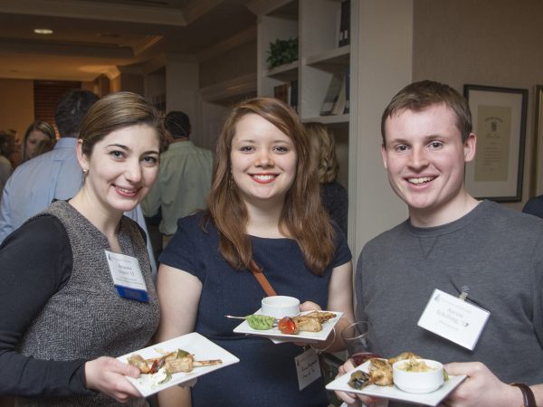 Three alumni attending a reception during Alumni Weekend at the Kirby Center.