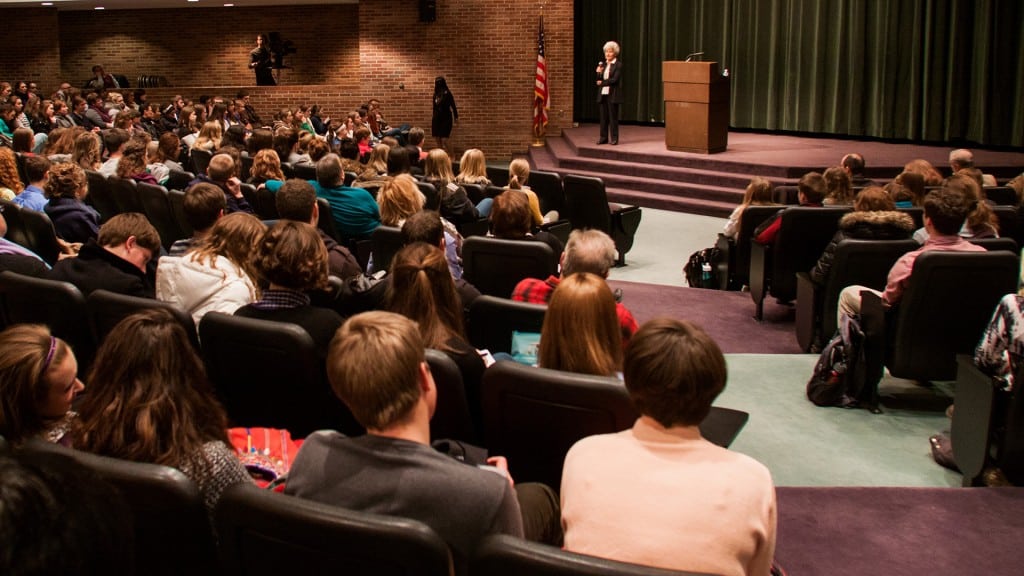 Miriam Winters giving a lecture to students in an auditorium.