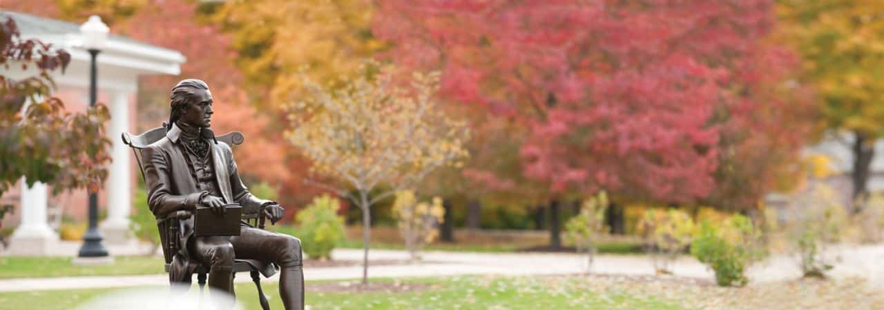Hillsdale College statue of Thomas Jefferson during autumn.