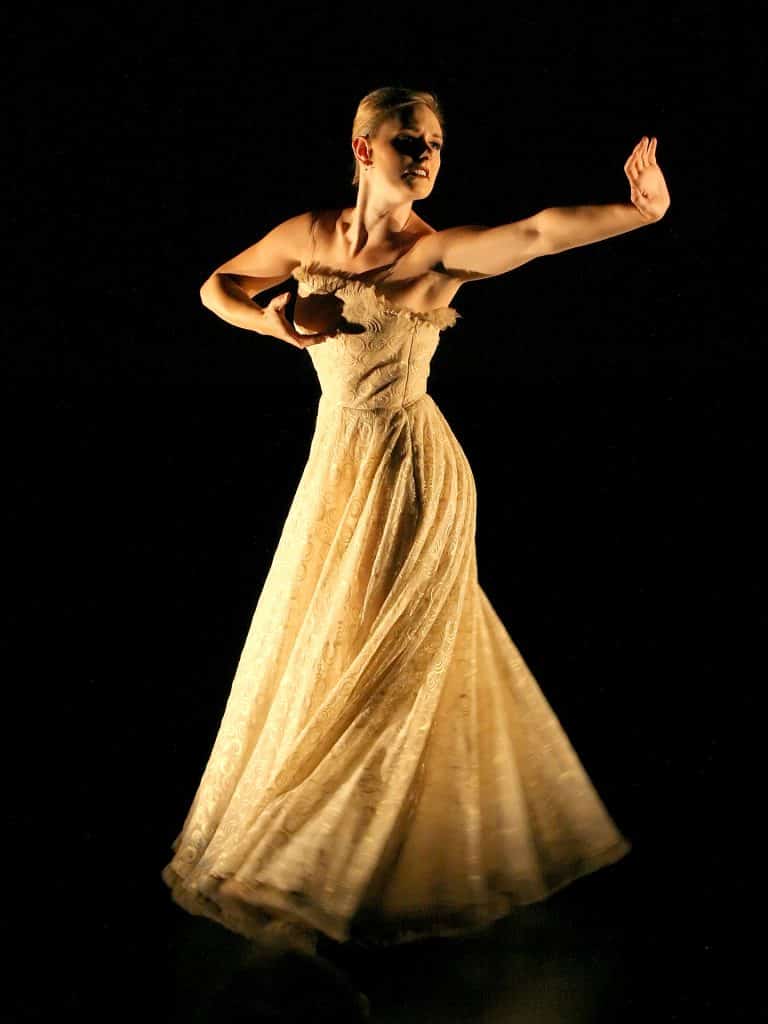 Holly Hobbs dancing in a yellow dress.