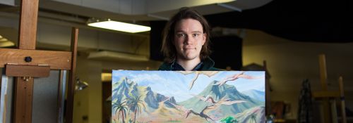 Forester McClatchey with his own artwork conceptualizing dinosaurs.