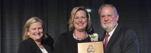 Beth Walker receiving a 2016 Alumni Award from Dr. Arnn.