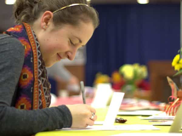 Student writing a thank you card