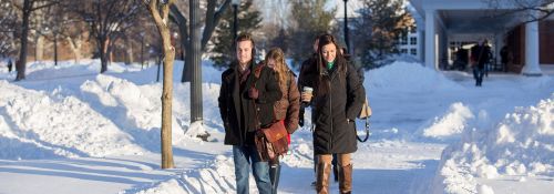 Students walk through snow