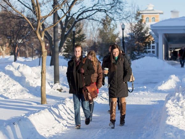 Students walk through snow