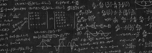 Physics equations filling a blackboard.