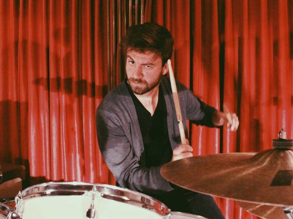 Dean Sinclair playing on a drumset.
