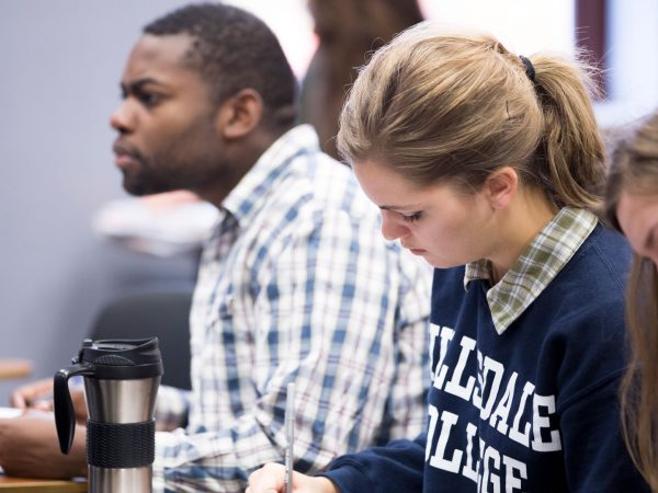 Several students taking notes during class.