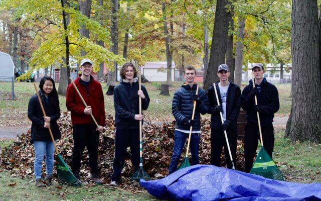 “A Few Good Men” volunteers raking leaves.