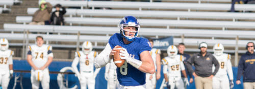 Hillsdale College football player preparing a throw during a game against Alderson Broaddus.