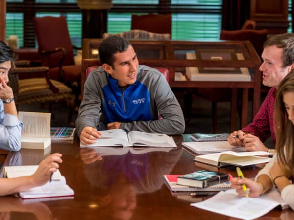 Students studying around a library table.