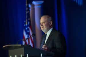 Larry Arnn giving lecture at a reception.