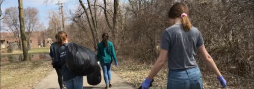 Students picking up trash for community service.
