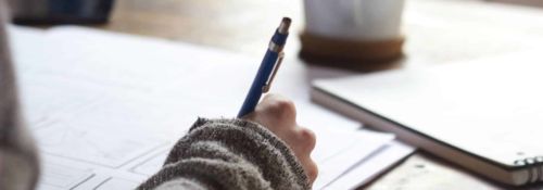 Student writing out homework.