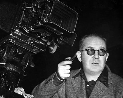 John Ford during movie filming, pipe in hand.