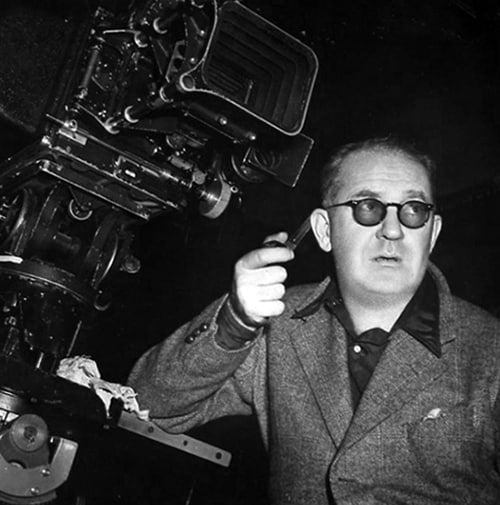 John Ford during movie filming, pipe in hand.