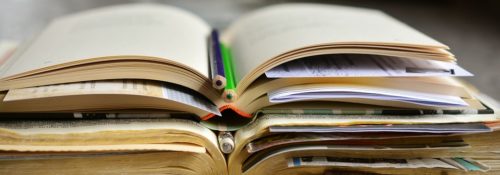 Books with bookmarks and colored pencils