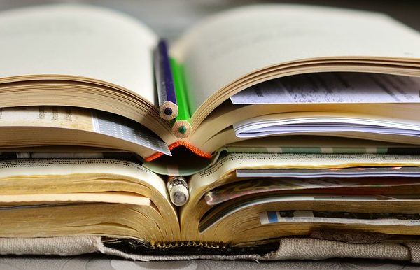 Books with bookmarks and colored pencils