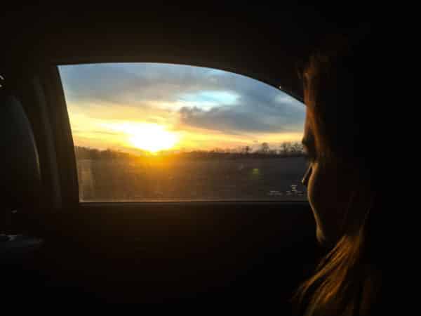 Girl looking out car window