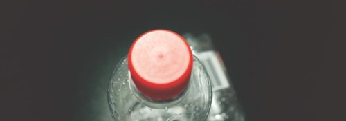 Closeup, top-down view of two plastic water bottles.