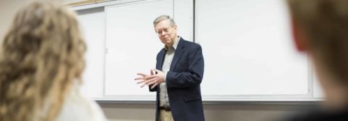 Paul Rahe teaching in front of the classroom.
