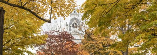 Hillsdale College clock tower through autumn leaves
