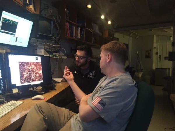 Physics professor and student in lab