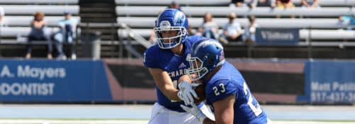 Hillsdale College football team handoff