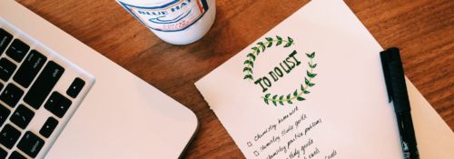 Laptop with coffee and notepad