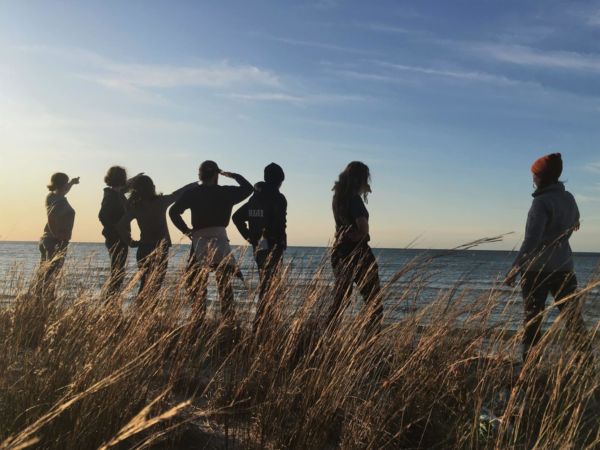 Students on beach at sunset
