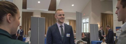 Student speaking with two others at classical school job fair