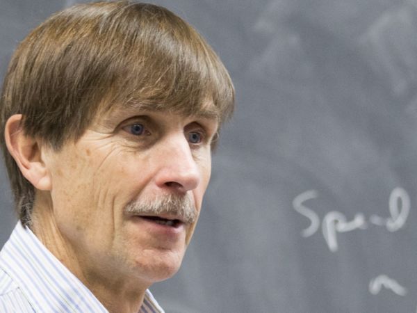 Economics Professor Gary Wolfram standing in front of a blackboard
