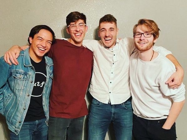 The four members of band Rourke Michael standing with arms around each other
