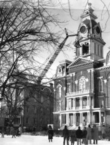 Central Hall Clocktower removes the bell via a large crane while a few onlookers watch