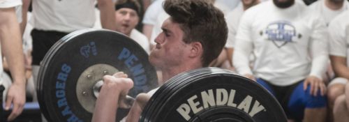 male student lifting weights