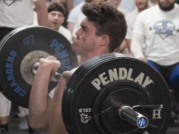 male student lifting weights